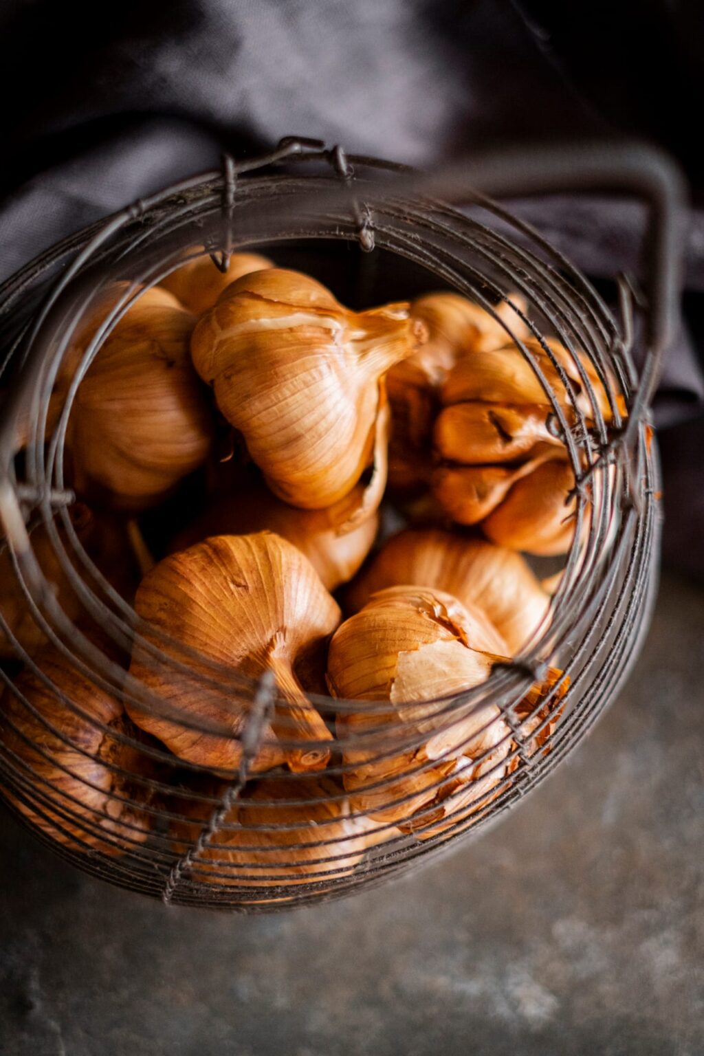 Smoked Garlic in metal basket top view