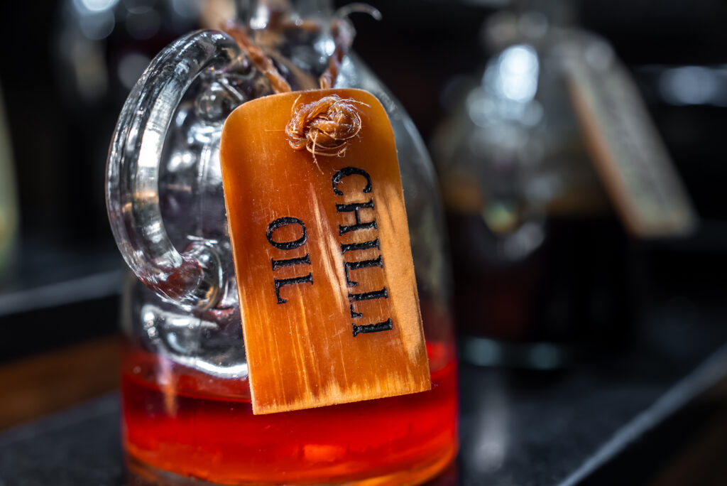 Smoked paprika and chilli finishing oil in a glass bottle
